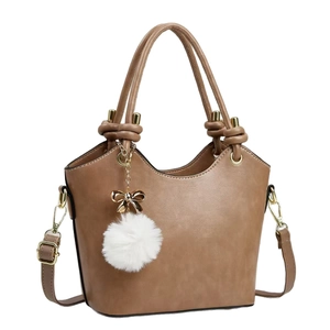 Brown bucket style handbag with top handles and a decorative white fur pompom accessory
