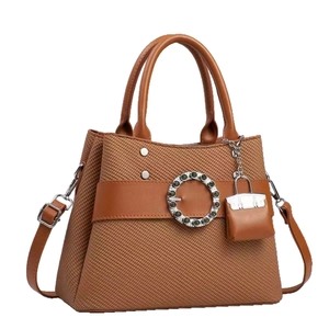 Brown woven tote bag with rhinestone buckle and matching mini charm pendant for women