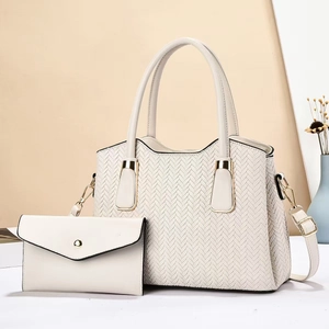 Vue détaillée d'un ensemble de sacs blancs à texture tissée et finitions métalliques
