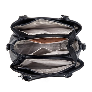 Interior detail of black leather handbag with three compartments and gray lining