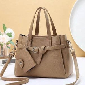 Detail of khaki lychee grain leather tote bag with matching coin purse and silver buckle