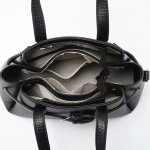 Top view of black pebbled leather tote with organized three-compartment interior