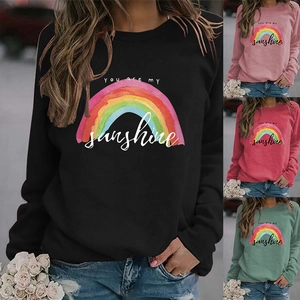 Detail of colorful rainbow print and You Are My Sunshine lettering on crewneck sweatshirt
