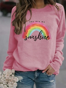 Detail shot of the rainbow print and You are my sunshine text on pink sweatshirt