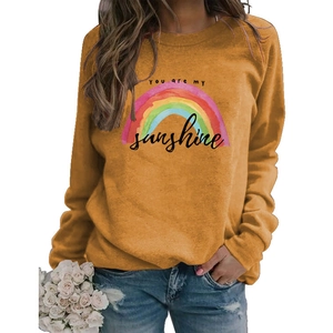 Detail of colorful rainbow print and You are my sunshine text on ginger yellow sweatshirt