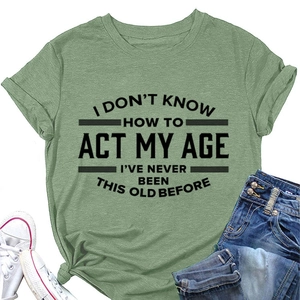 Groen katoenen T-shirt met tekstprint, gestyled met jeans en witte canvas schoenen op de grond