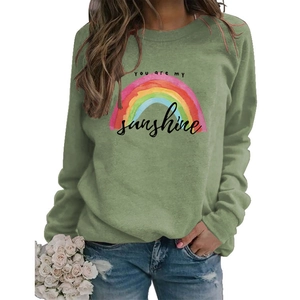 Close-up of rainbow print and You are my sunshine text on green long sleeve sweatshirt
