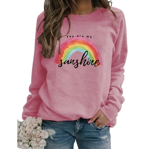 Detailed view of pink long sleeve sweatshirt with rainbow print and sunshine text