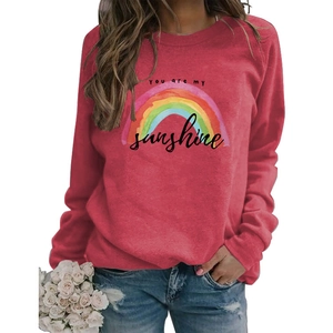 Detail of red crewneck sweatshirt with rainbow print and YOU ARE MY sunshine text design