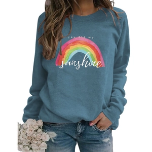 Detail of blue crewneck sweatshirt with You are my sunshine rainbow print and soft texture