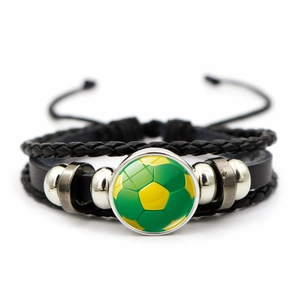 Detail of adjustable soccer bracelet with green football glass gem and leather cord
