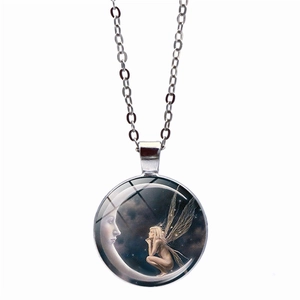 Silver necklace featuring a moon and angel glass cabochon pendant on a white background