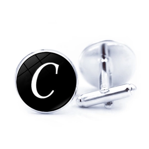 Classic silver metal cufflinks with a black round face featuring a white serif letter C