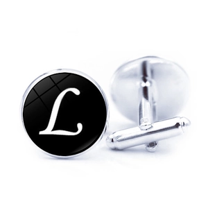 Macro view of silver metal cufflinks with letter L design and bullet back closure