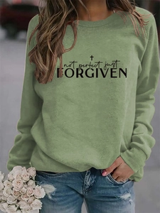 Close-up of olive green crewneck sweatshirt with Not Perfect Just Forgiven printed design