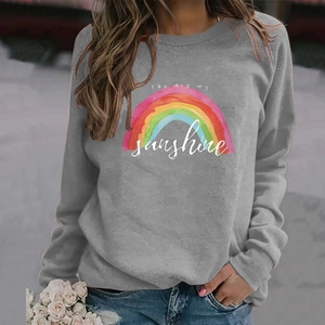 Grey You Are My Sunshine rainbow print sweatshirt on a model in an outdoor setting
