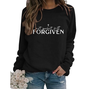Detail of white Not Perfect Just Forgiven graphic print on black long sleeve sweatshirt