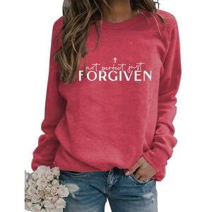 Detail showing red sweatshirt fabric with white cross and religious slogan print