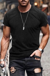 Close-up of slim fit black cotton t-shirt fabric and crew neck collar on urban model