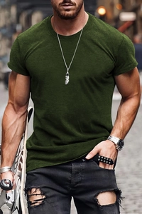 Close-up of slim-fit dark green crew neck cotton t-shirt worn by model in street setting