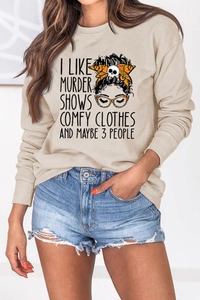 Detail of apricot crewneck sweatshirt featuring artistic slogan and graphic illustration