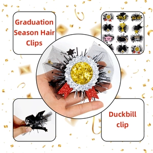 Detail of graduation hair clip featuring black mesh, mini hat and GRAD lettering