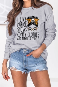 Detail of grey crewneck sweatshirt featuring artistic portrait print and letter graphics