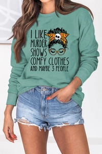 Sage green crewneck sweatshirt detail featuring female cartoon print and artistic lettering