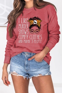 Detail of red crewneck sweatshirt with slogan print and ribbed cuffs on model