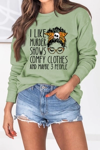 Close-up of I LIKE MURDER SHOWS print on light green long sleeve sweatshirt fabric