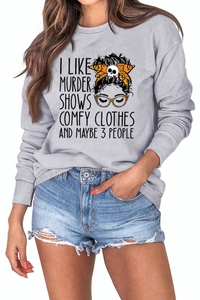 Detail of grey crewneck sweatshirt featuring I Like Murder Shows slogan and skull bow graphic