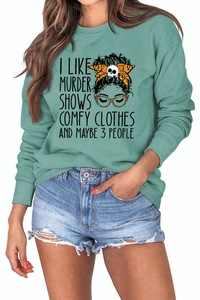 Close-up of funny quote print on soft teal crewneck sweatshirt with female illustration