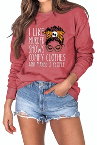 Detail of red crewneck sweatshirt featuring hand-drawn graphic and murder show text