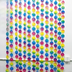 Close-up of rainbow gradient fringe curtain with white smiley face circular sequins