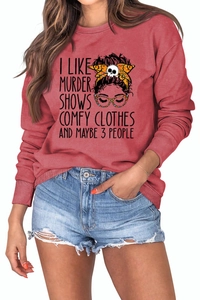 Close-up of the graphic slogan and cartoon character on the red long sleeve sweatshirt
