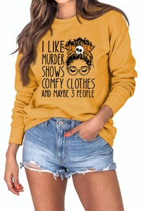 Macro shot of mustard yellow sweatshirt fabric and graphic print on casual crew neck