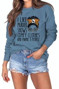 Detail of blue crewneck sweatshirt featuring I LIKE MURDER SHOWS graphic print and soft fabric