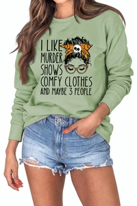 Detail of light green sweatshirt with graphic print I LIKE MURDER SHOWS and glasses design