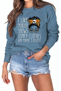Detailed close-up of long sleeve blue sweatshirt with character and quote print