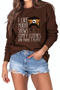 Close-up of crewneck sweatshirt with girl print and I Like Murder Shows text detail