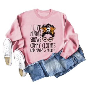 Flat lay of pink crewneck sweatshirt with illustration styled with jeans and canvas shoes