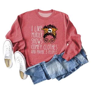 Flat lay of red crewneck sweatshirt with 'I Like Murder Shows' text and graphic