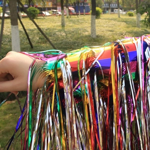 Detailed close-up of colorful metallic tinsel fringes with a vibrant rainbow gradient effect