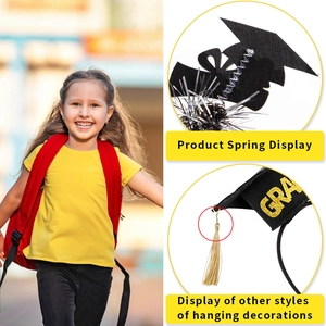 Detail of graduation headband with black mini cap, gold glitter GRAD text and silk tassel