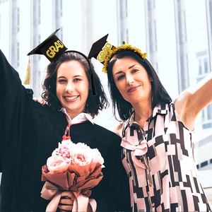 Detail of graduation headband with black mini mortarboard and gold glitter GRAD text