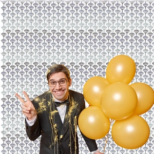Close-up of metallic gold balloons being held in a celebratory party background
