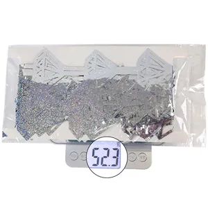 Detailed view of silver laser birthday fringe curtain package weighing 52.3g on a scale