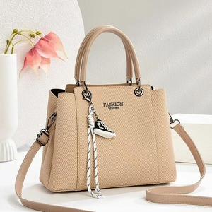 Khaki quilted handbag with FASHION Queen print and sneaker charm on minimalist background