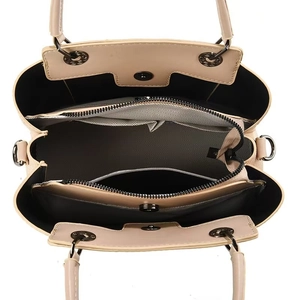 Top view of the interior compartment layout of this beige handbag with dark metal hardware