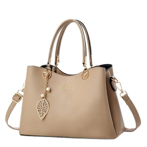Elegant khaki pebble grain leather handbag with gold leaf pendant and pearl detail